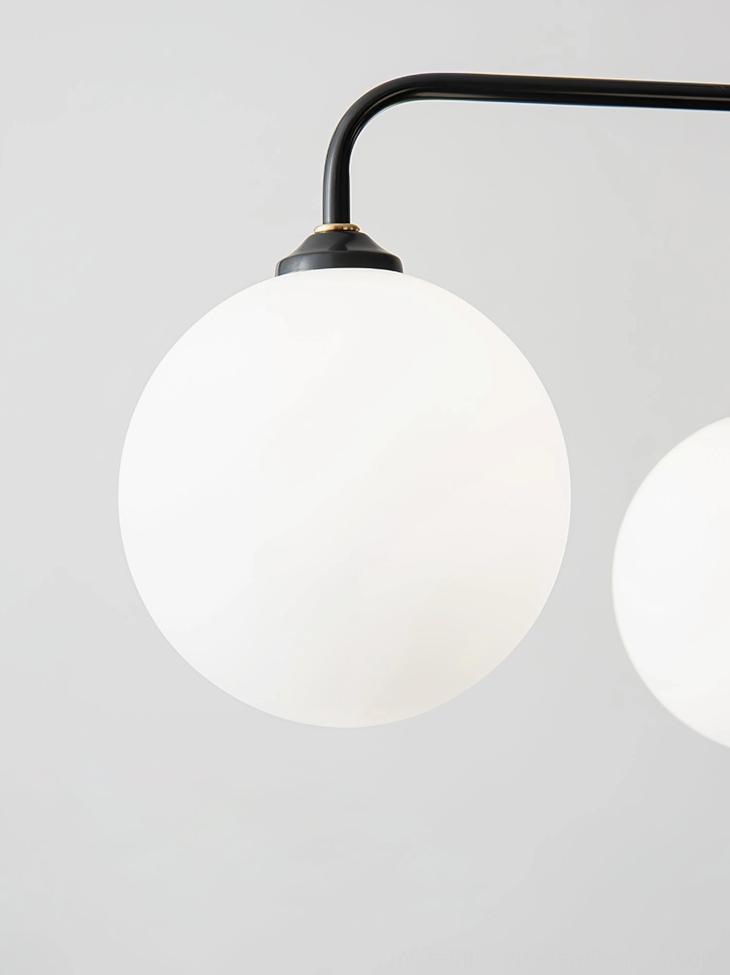 Close-up detail of Lune chandelier frosted milk glass shades with metallic frame construction