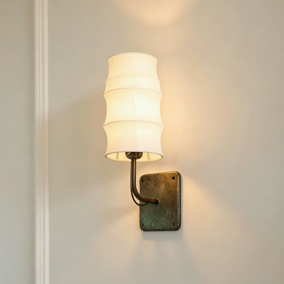 Architectural wall-mounted Maeve Lantern Sconce with multi-tiered fabric shade and aged verdigris metal hardware