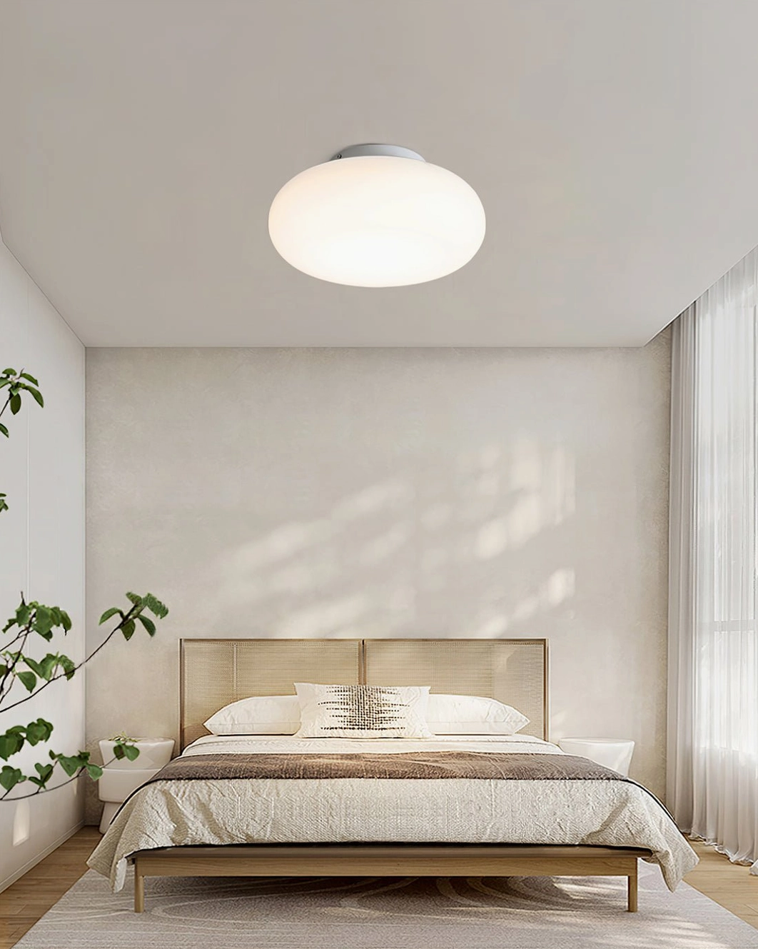 Maga ceiling light installed in Nordic master bedroom with green plant, minimalist interior design