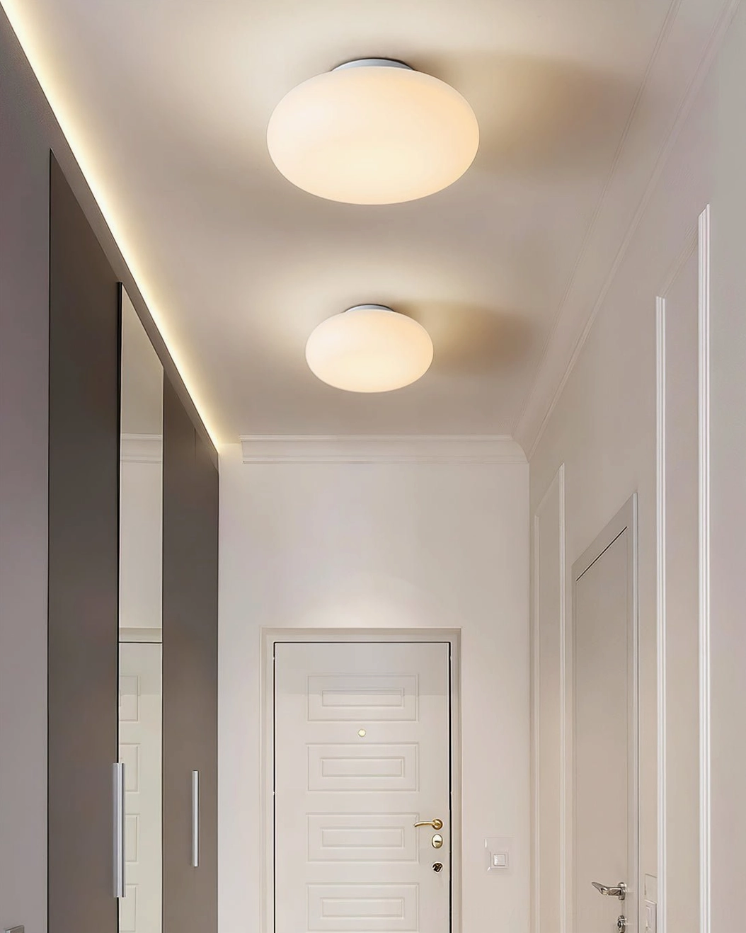 Multiple Maga flush mount ceiling lights in residential hallway with white doors, soft ambient lighting