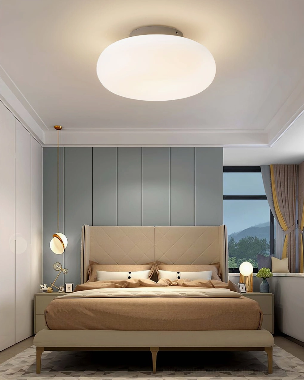 Maga flush ceiling light in luxury master bedroom with tufted headboard and wall sconces, ambient lighting