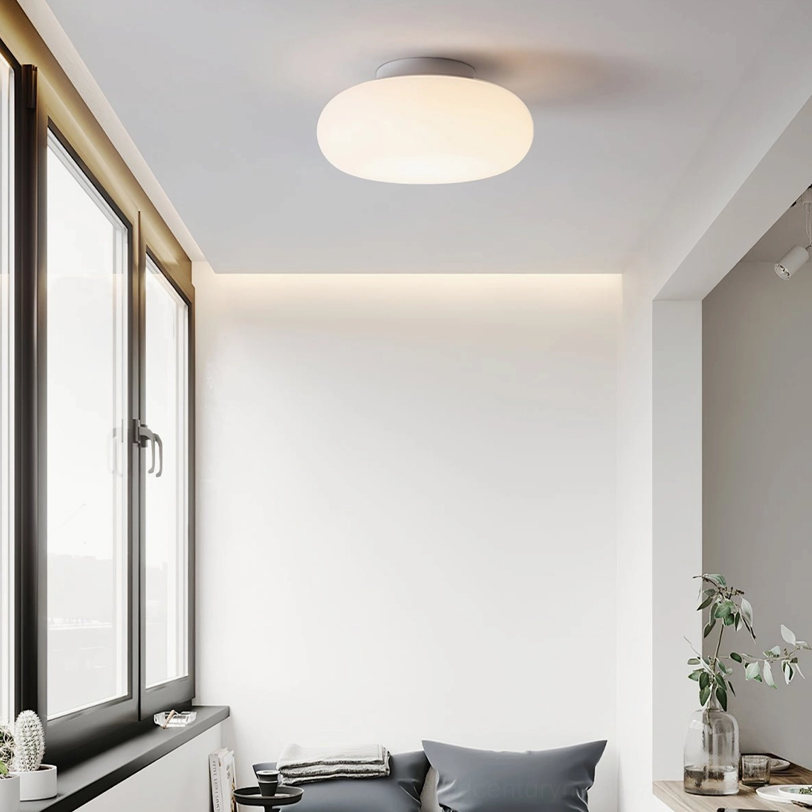 Maga ellipsoid ceiling light paired with minimalist bedroom furnishings and natural textures