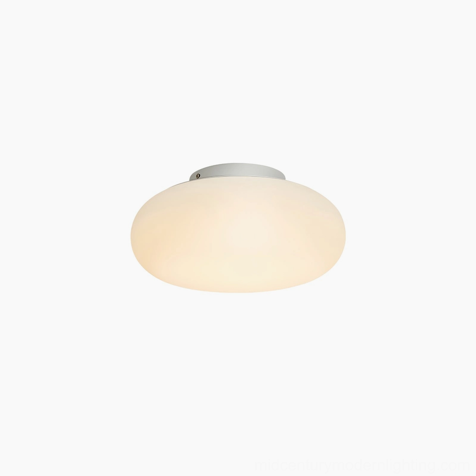 Maga flush ceiling light creating warm ambient glow in modern minimalist living space