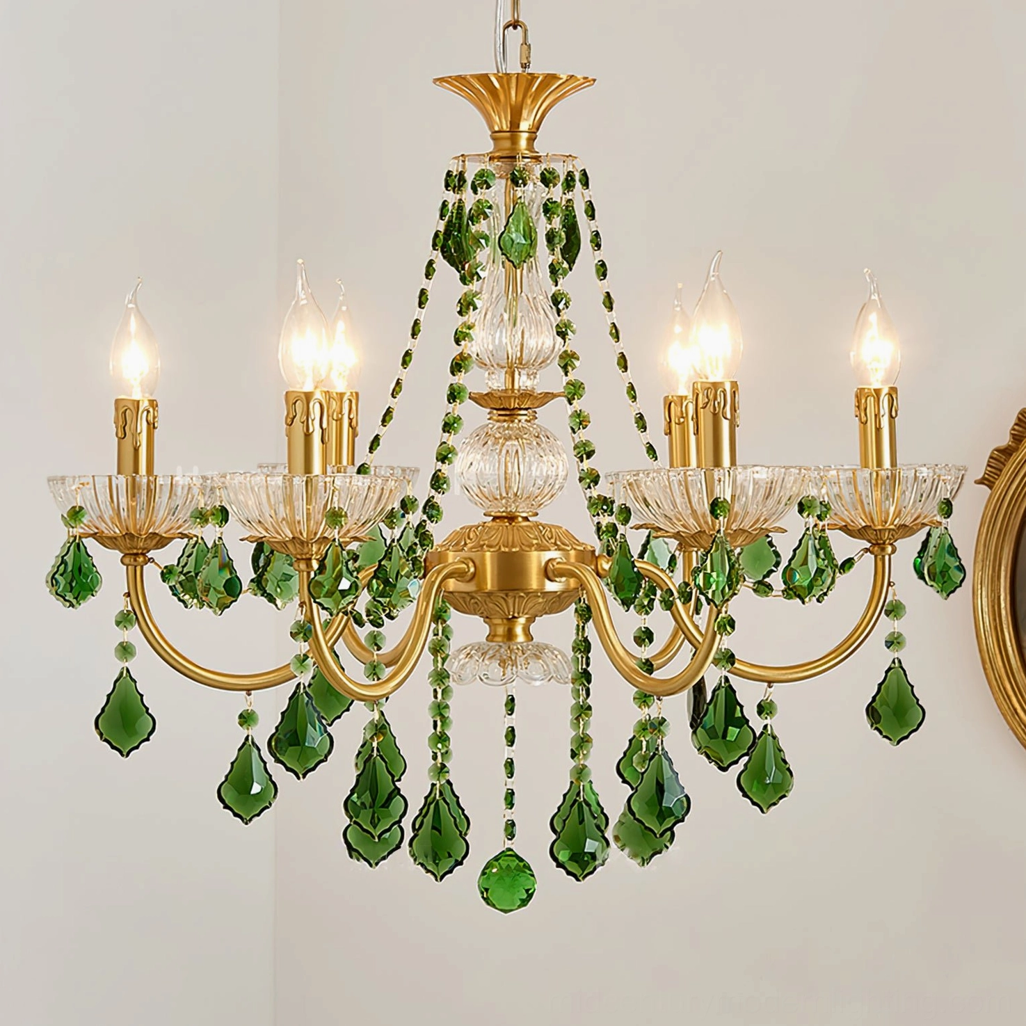 Magdalena brass chandelier illuminated showing light refraction through green crystals