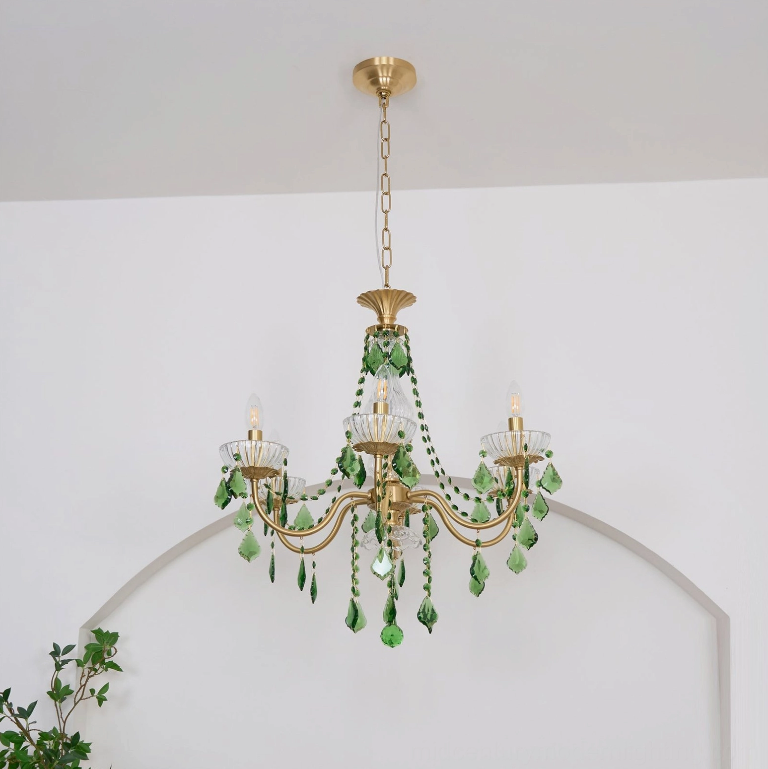 Magdalena brass and crystal chandelier low angle view beneath archway elegant ambiance