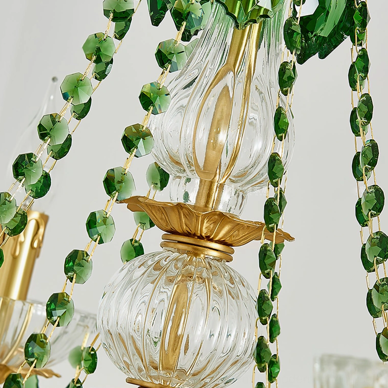 Detailed shot of Magdalena chandelier hanging crystal strands and brass suspension