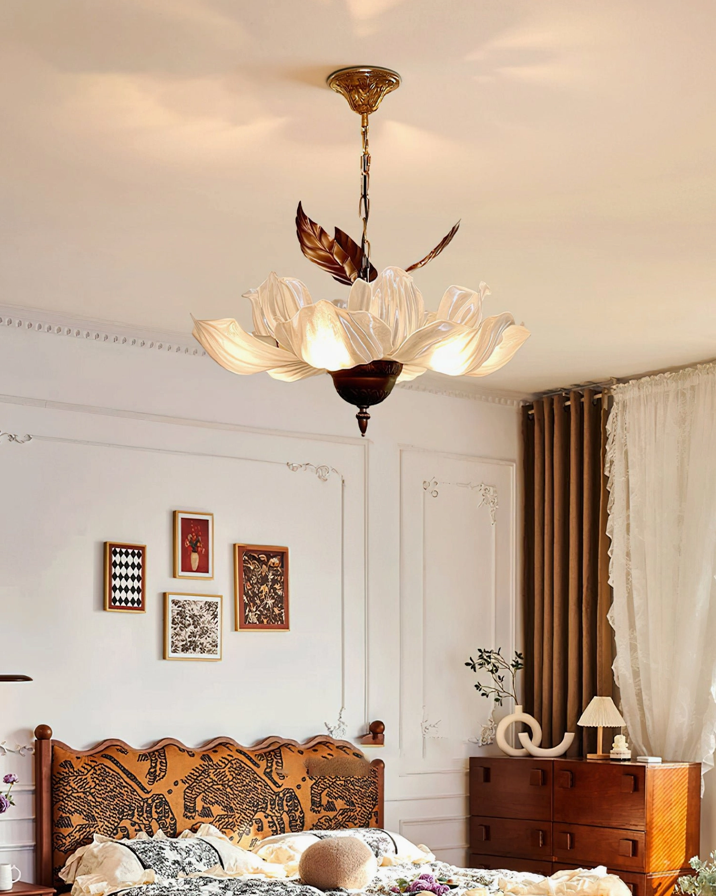 Magnolia Bloom Chandelier in minimalist bedroom with carved wooden headboard and gallery wall