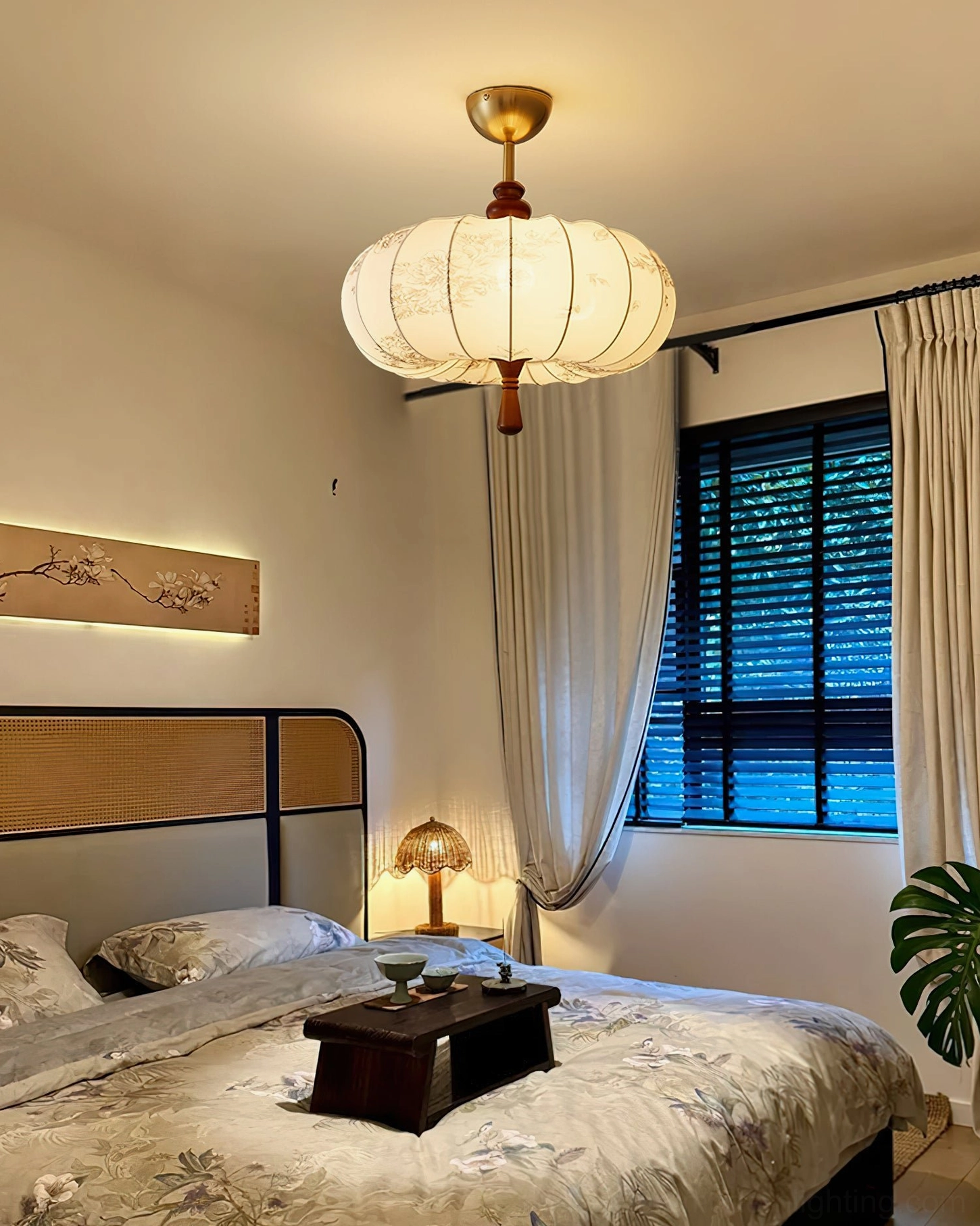Modern bedroom with Mantis fabric ceiling light above bed and window blinds, warm minimalist home aesthetic