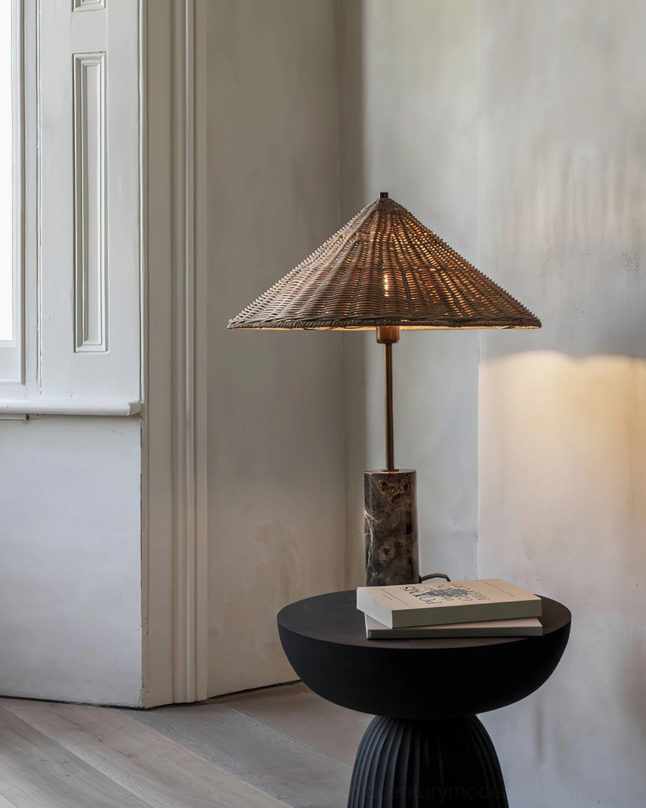 Marble rattan table lamp in modern living room setting - styled on black side table with books and decor