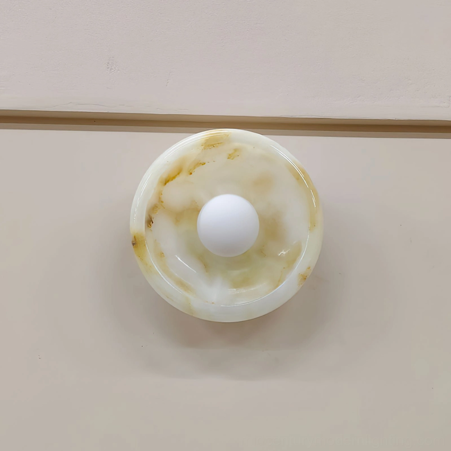 Marble wall lamp accent lighting for interior space, warm ambient glow on neutral wall surface