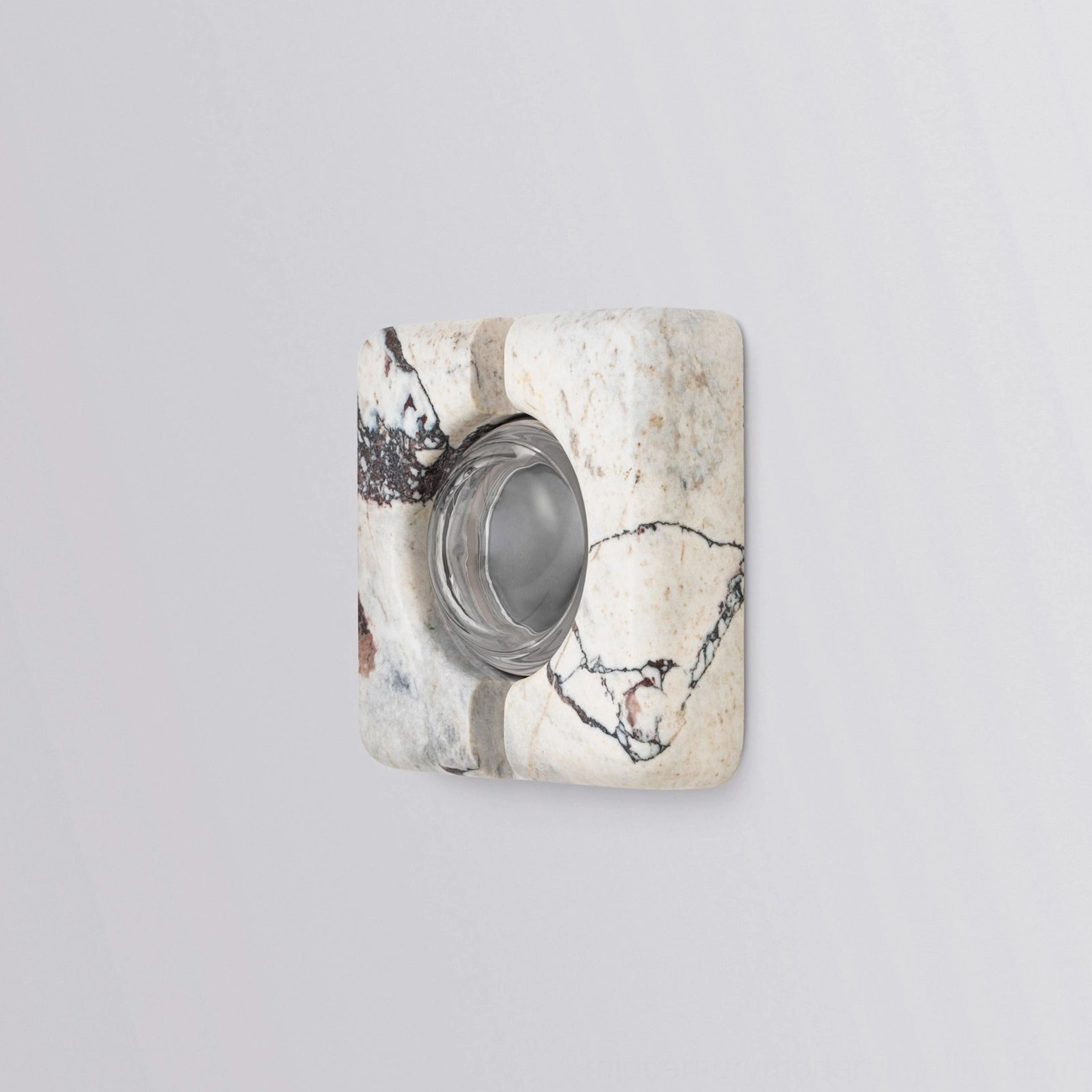 Three-quarter angle view of unlit recessed marble wall lamp showing geometric form