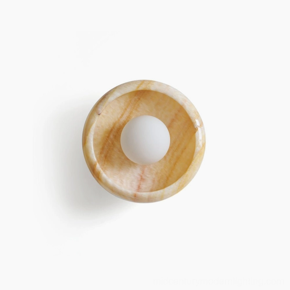 Elegant marble wall lamp with light beige natural stone, warm neutral color palette direct front view on plain backdrop