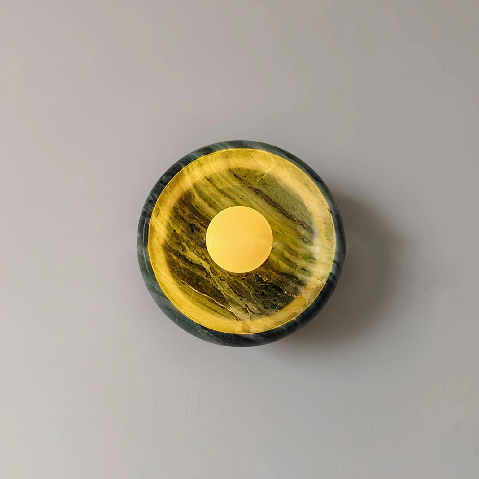 Natural marble wall lamp with distinctive veining patterns, sculptural modern design element