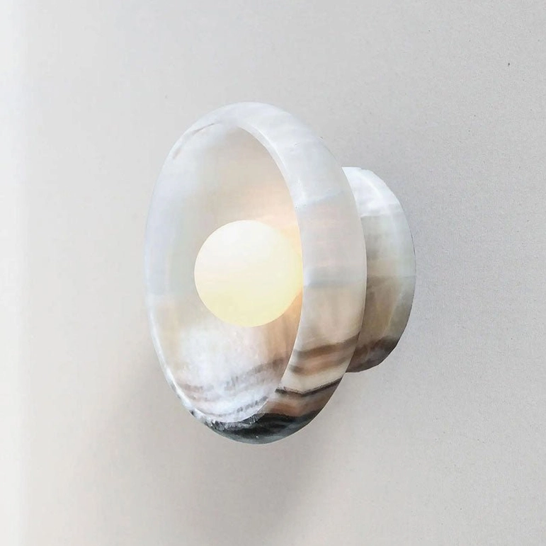 Marble wall lamp close-up view of natural stone texture and lighting fixture quality