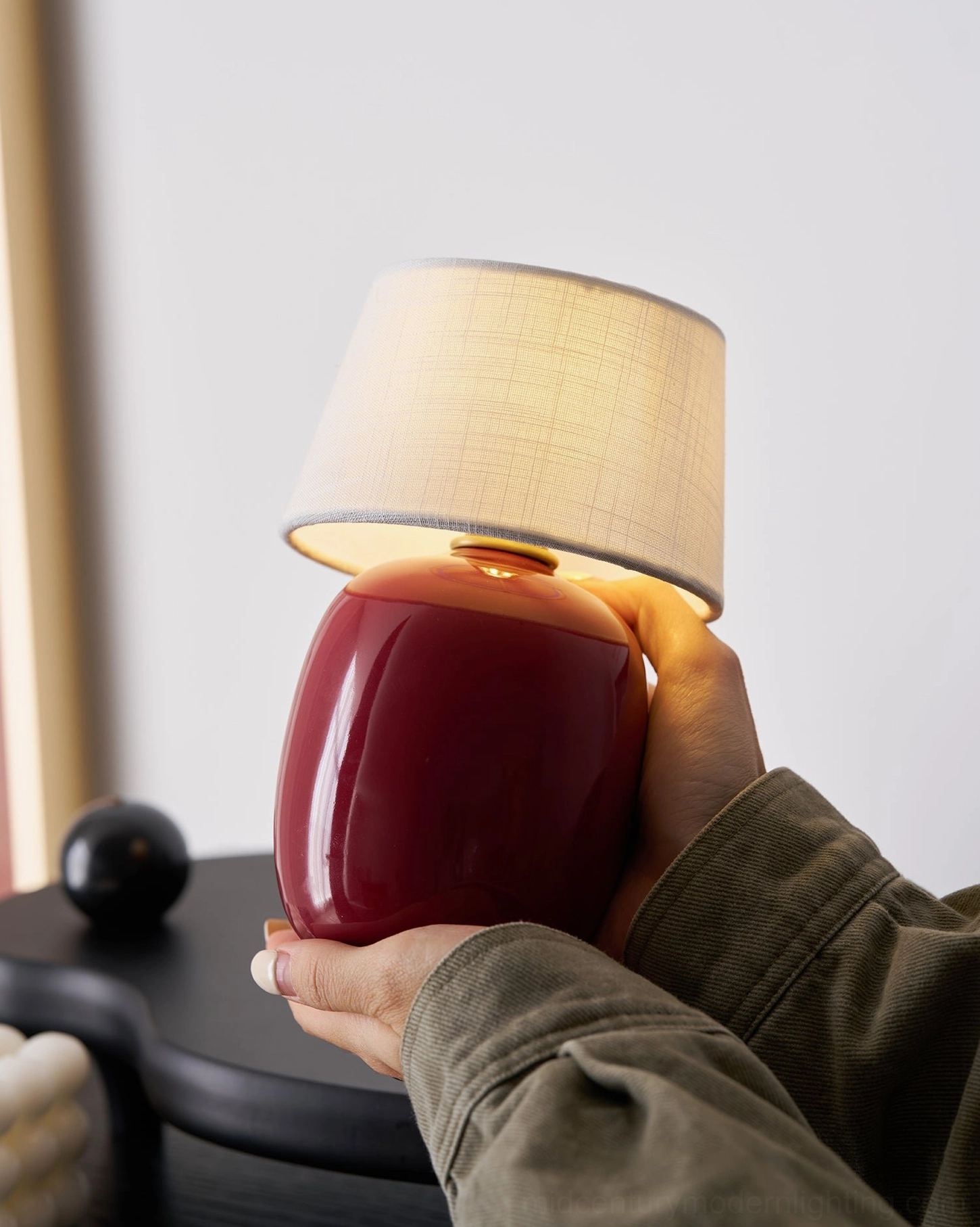 Marie table lamp black ceramic base with polished brass finial detail