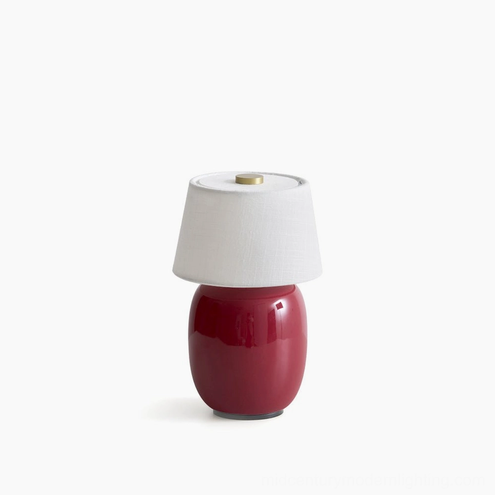 Marie ceramic table lamp with red base and white fabric shade, studio product photography