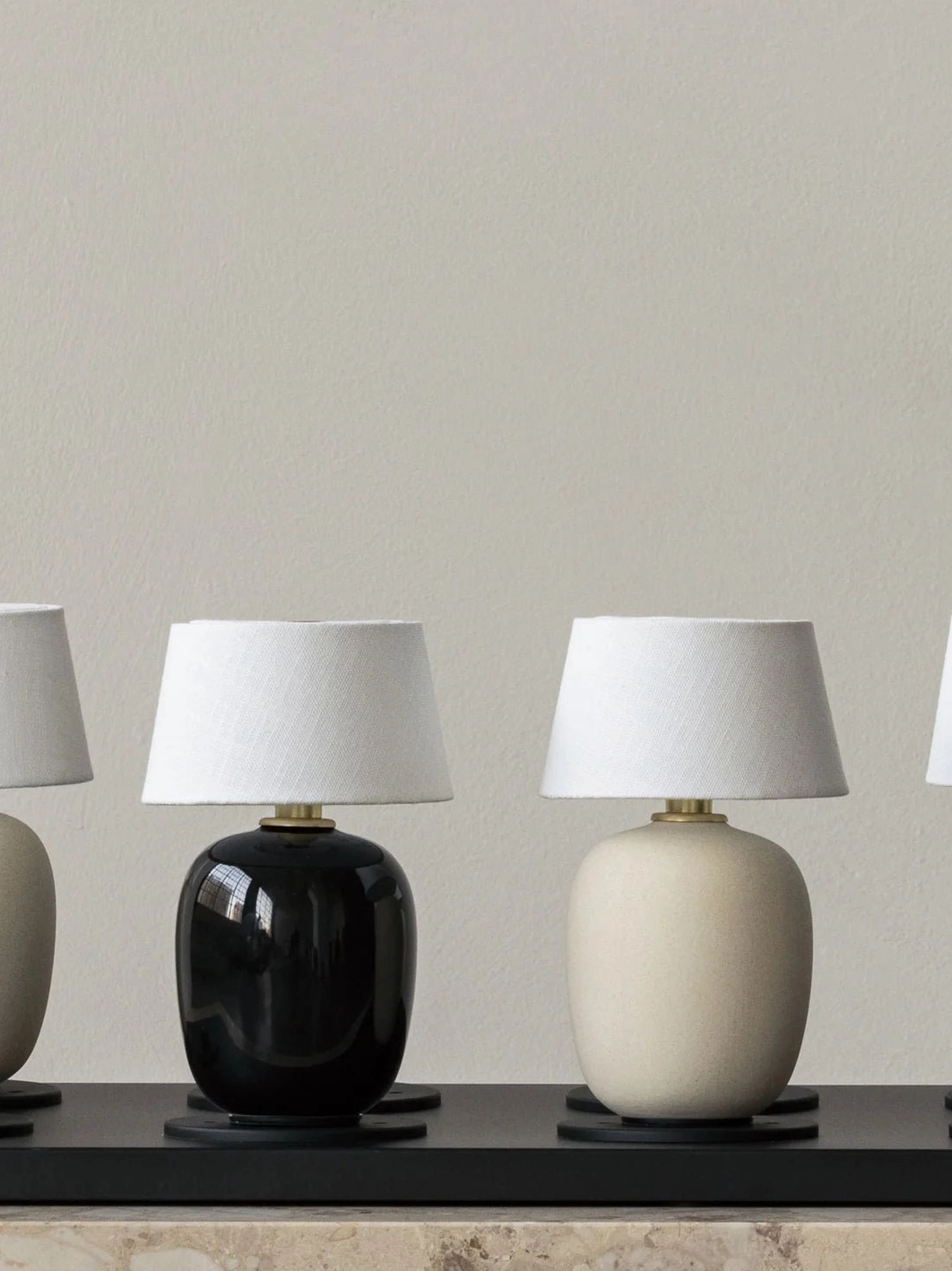 Marie ceramic table lamp sand color variant on display surface