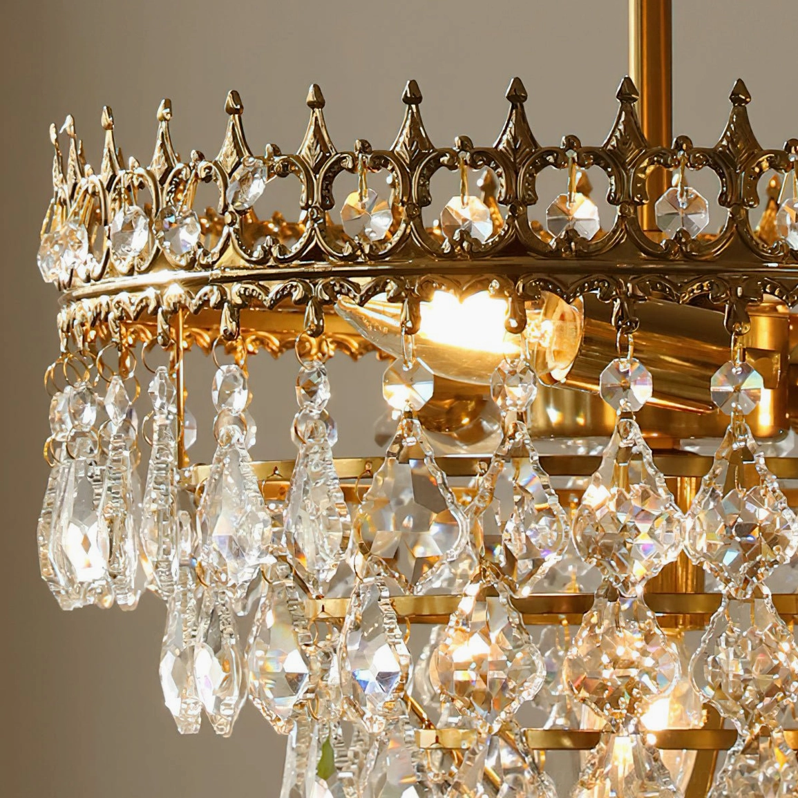 Marilyn Crystal Chandelier crystal refraction detail, light play through clear facets with prismatic patterns on ceiling and walls