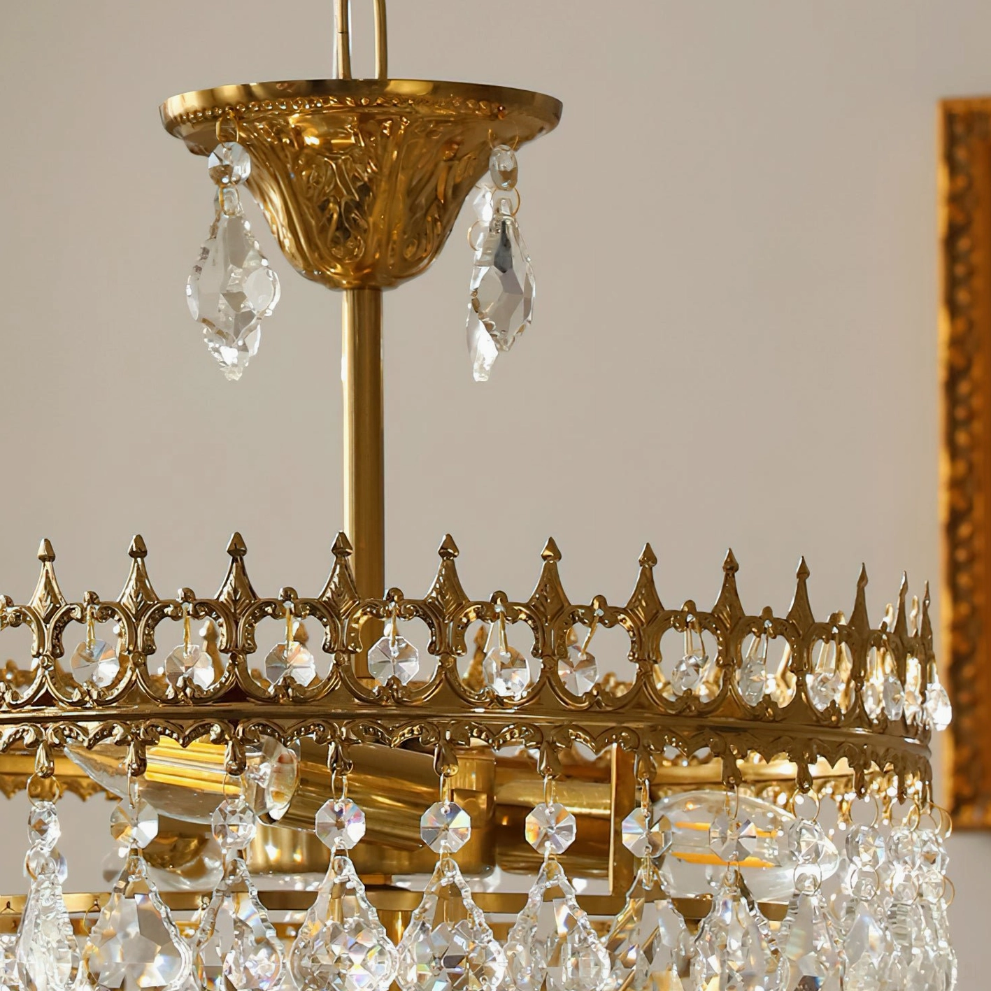 Marilyn Crystal Chandelier side angle view, showcasing crystal depth and tiered arrangement with warm brushed gold finish