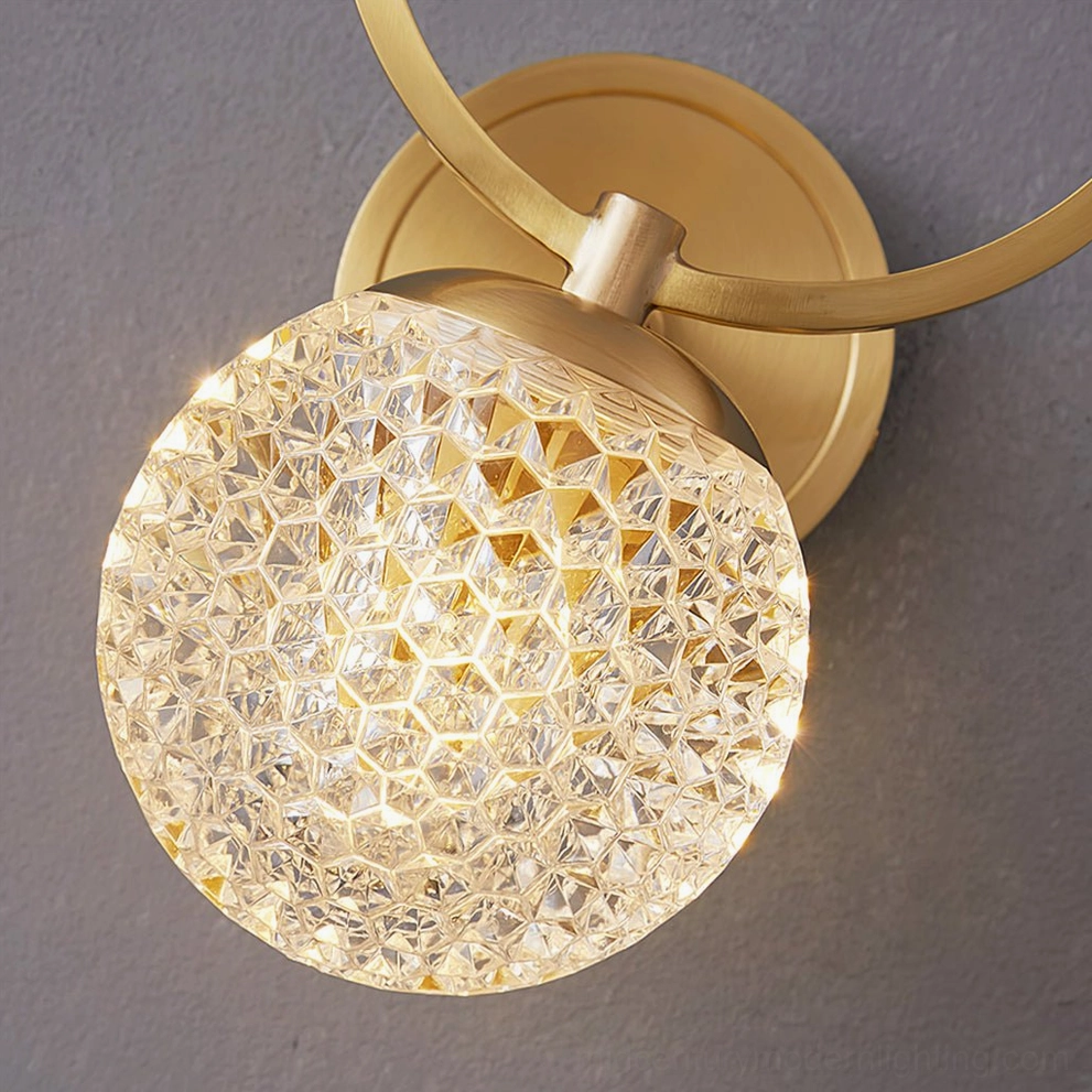 Close-up detailed view of Marni Wall Sconce large faceted spherical crystal glass with exposed brass gold metal hardware
