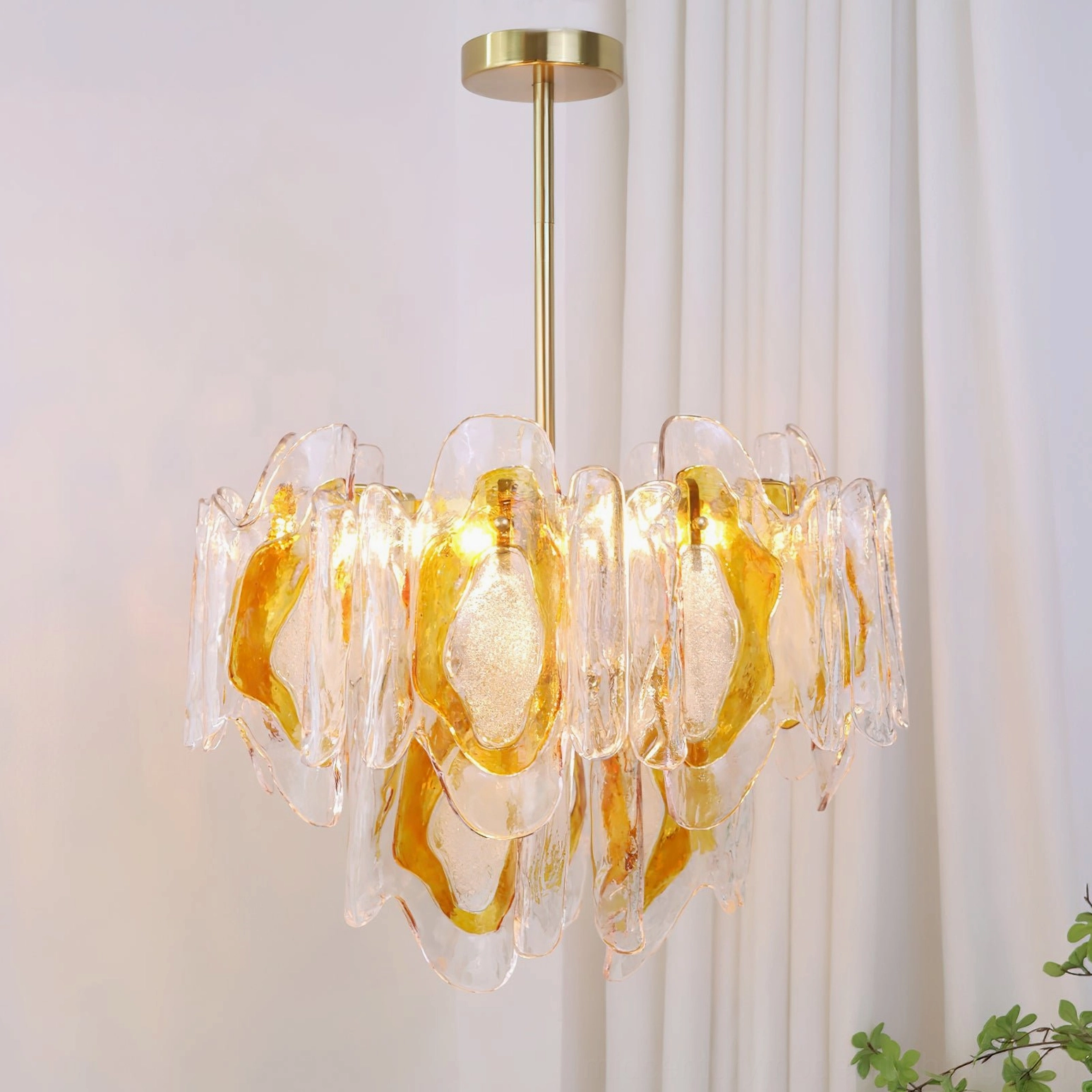 Marrina amber glass pendant chandelier front view overhead angle in modern room with warm brass illumination