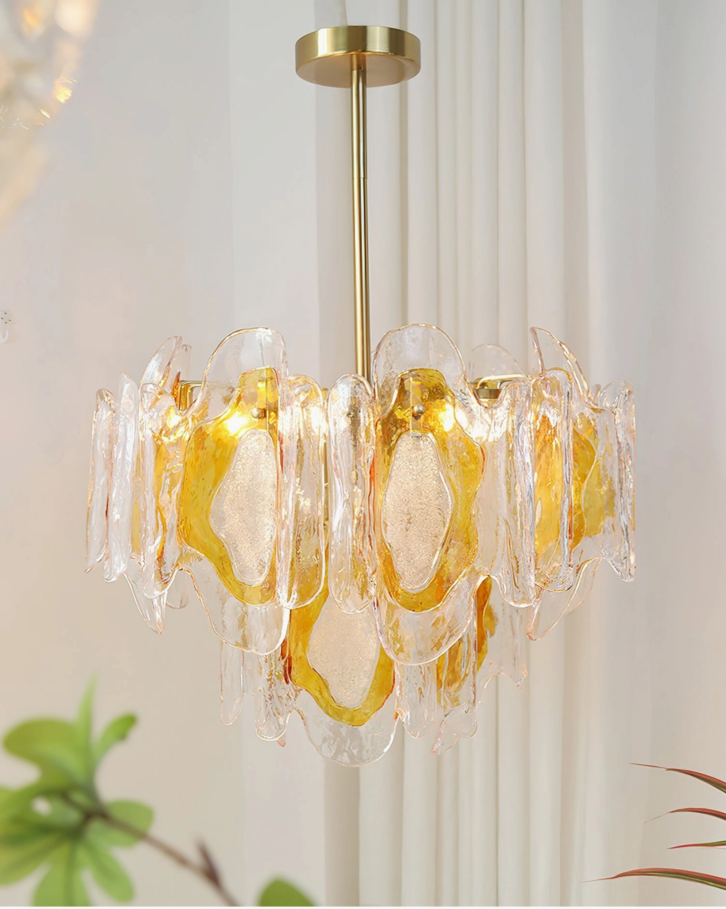 Marrina mid-century modern glass chandelier three-quarter angle showing clear amber gradient glass design