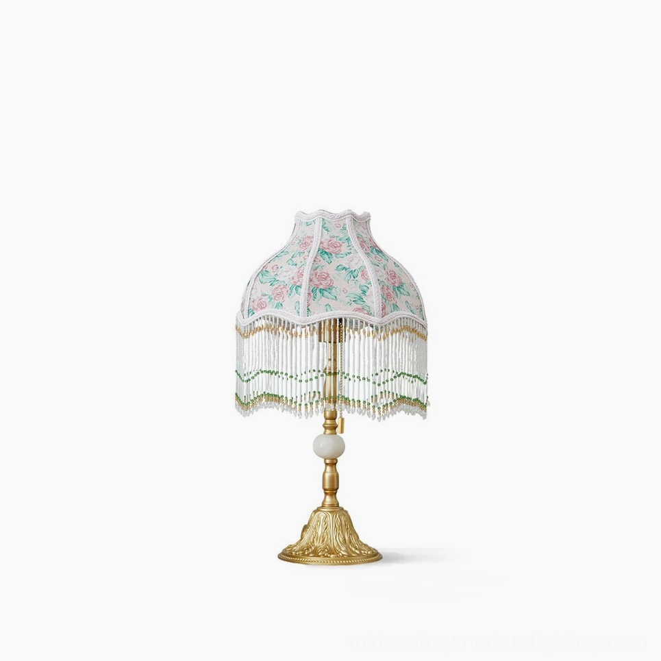 Masa beaded floral table lamp front view with ornate gold carved metal base and pink rose fabric shade with green tassel fringe