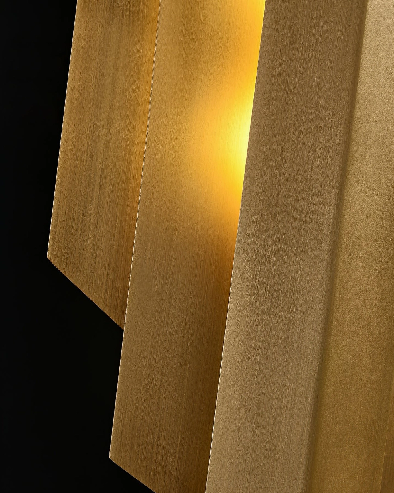 Pair of matching polished brass Art Deco wall sconces in luxury formal living room with velvet sofa