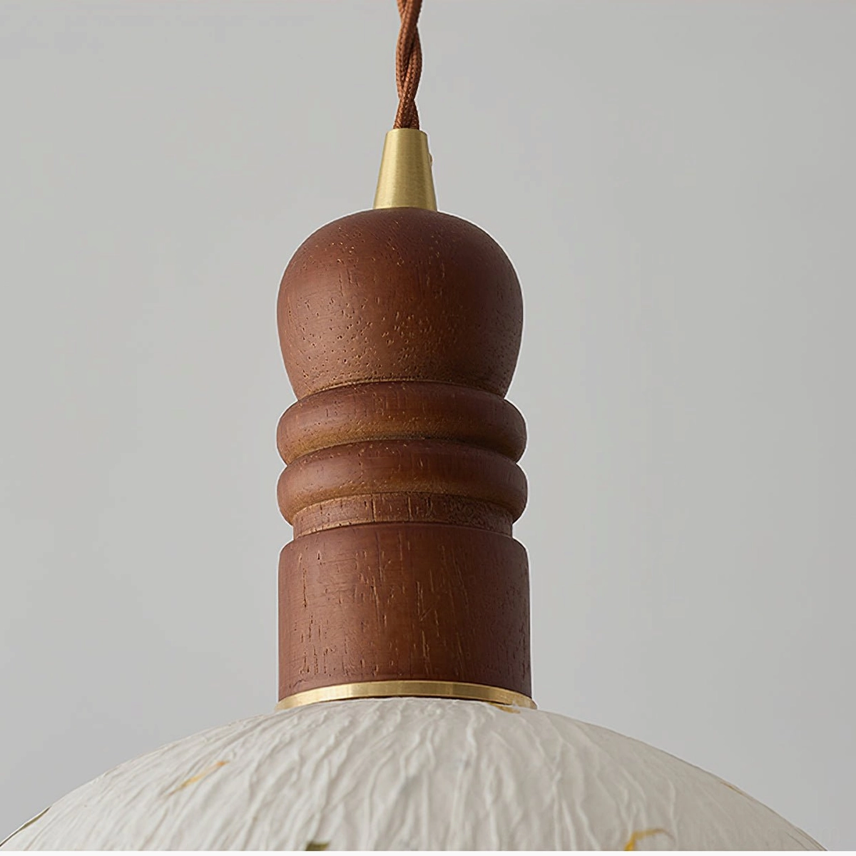 Dual Diana pendant lights suspended over dining table with wooden chairs and rattan seating, mid-century modern style
