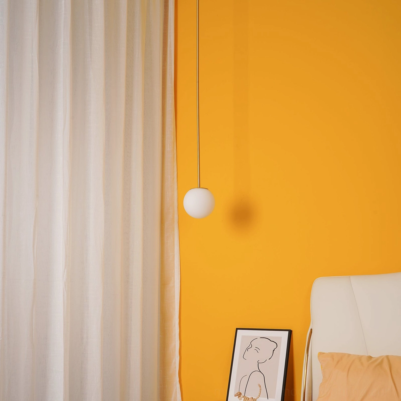 Matte black brass suspension pendant with opal glass globe in modern loft setting