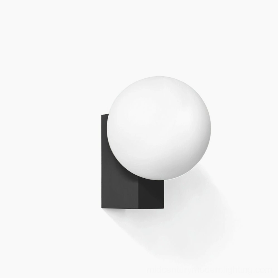 Geometric globe wall sconce with matte black bracket and frosted white glass sphere - minimalist modern lighting design close-up