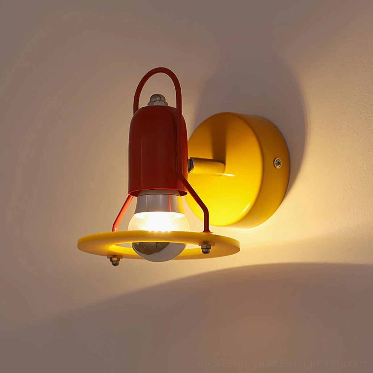 Maurer wall lamp front view with dark red body casting warm light on wall, contemporary design