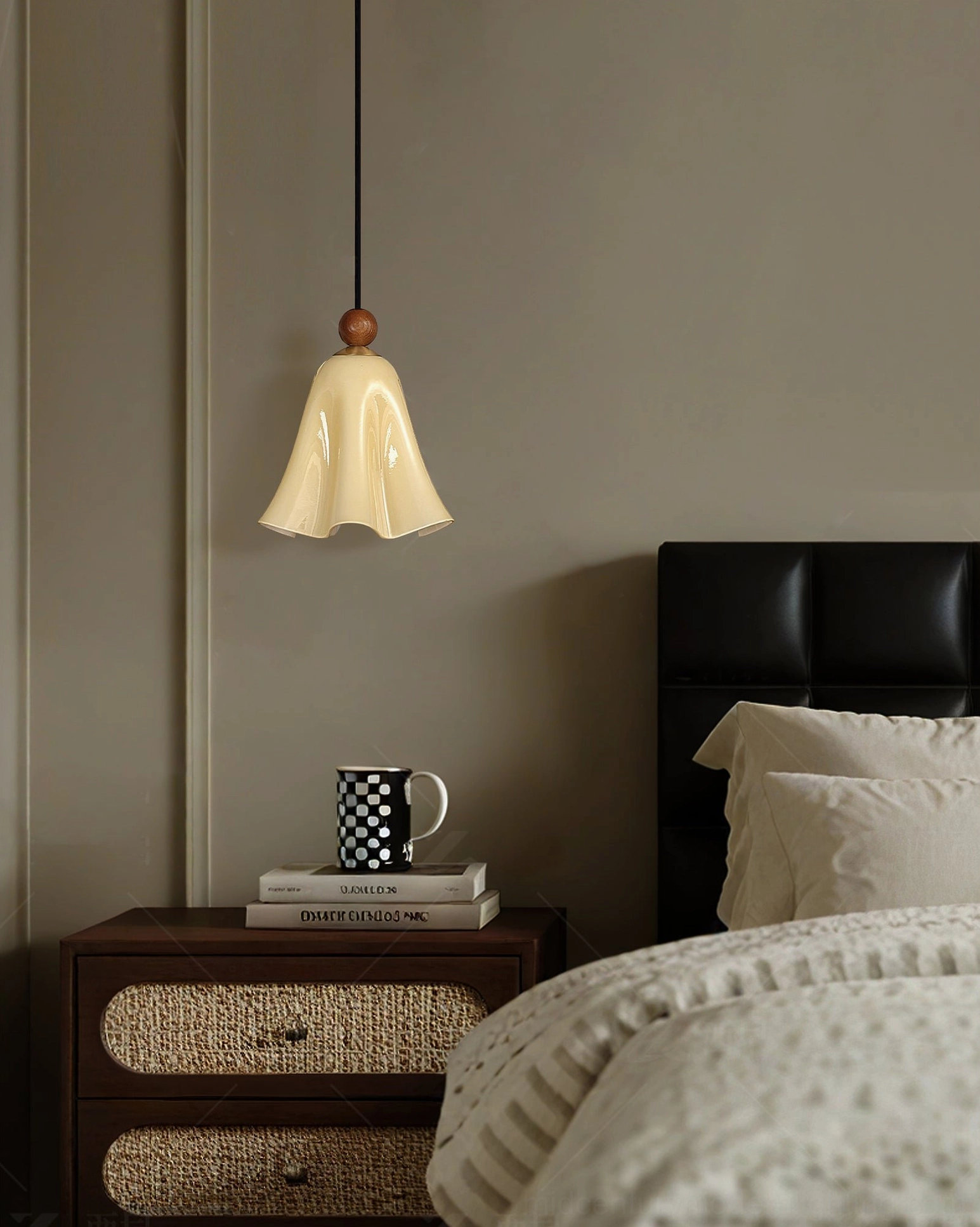 Cream Meblo mid-century pendant light hanging above minimalist bedroom with leather headboard and book stacks
