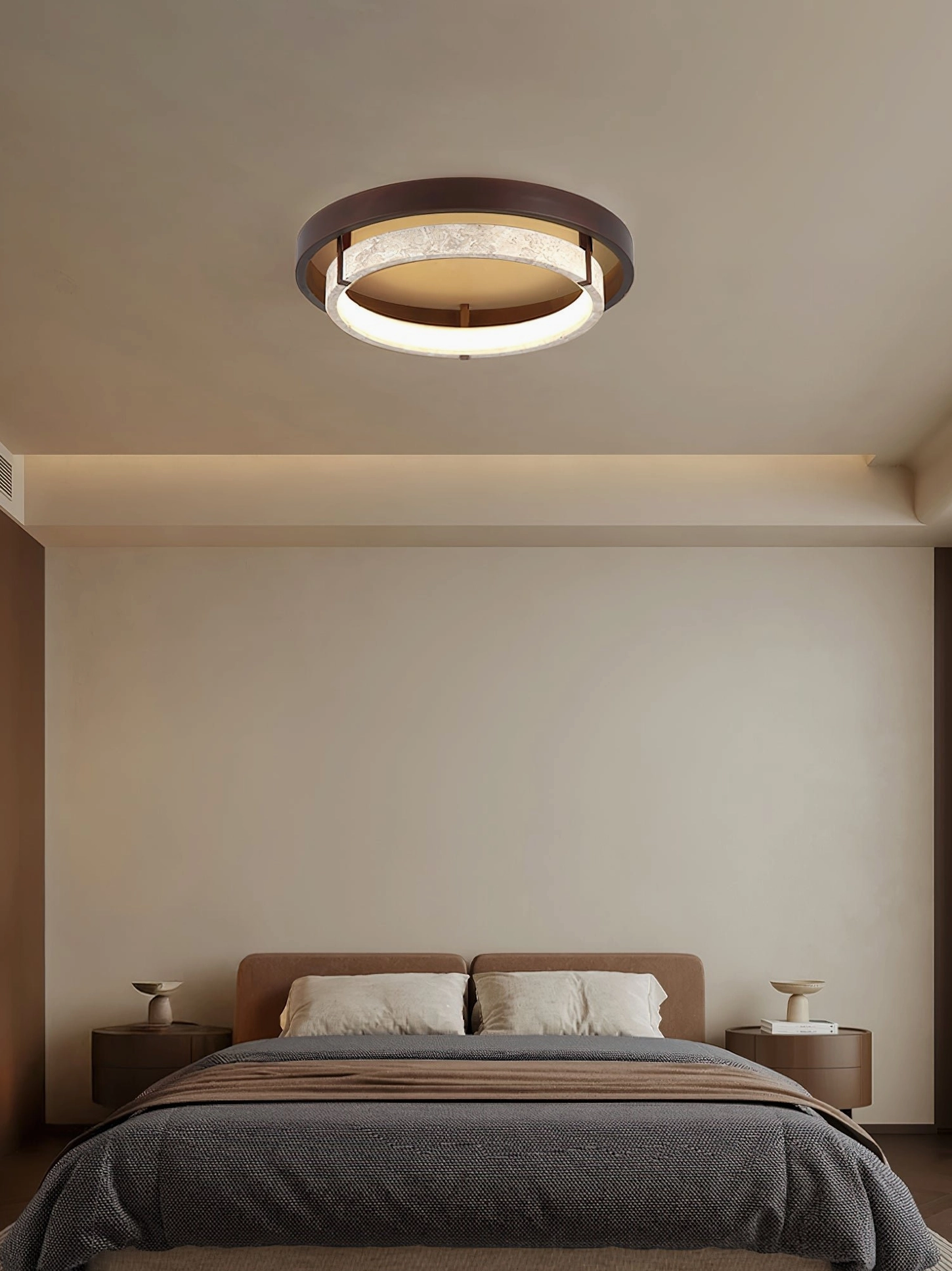 Warm walnut and travertine ceiling light in cozy minimalist master bedroom setting