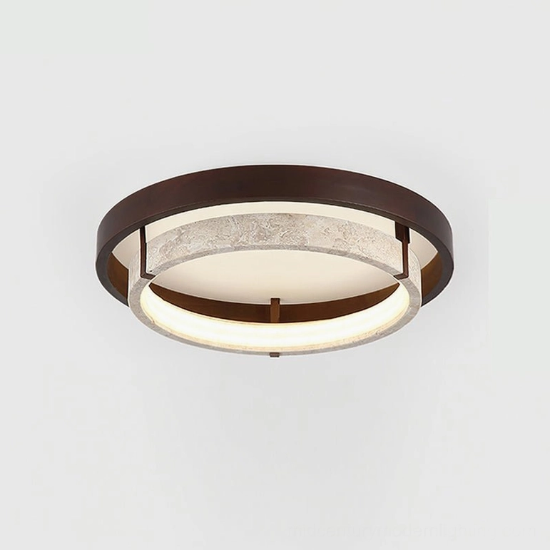 Detailed close-up of authentic travertine textured surface on modern flush mount ceiling light