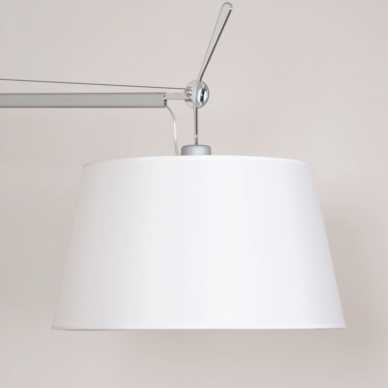 Mid-century modern articulating lamp with silver metal construction, versatile positioning for various room styles