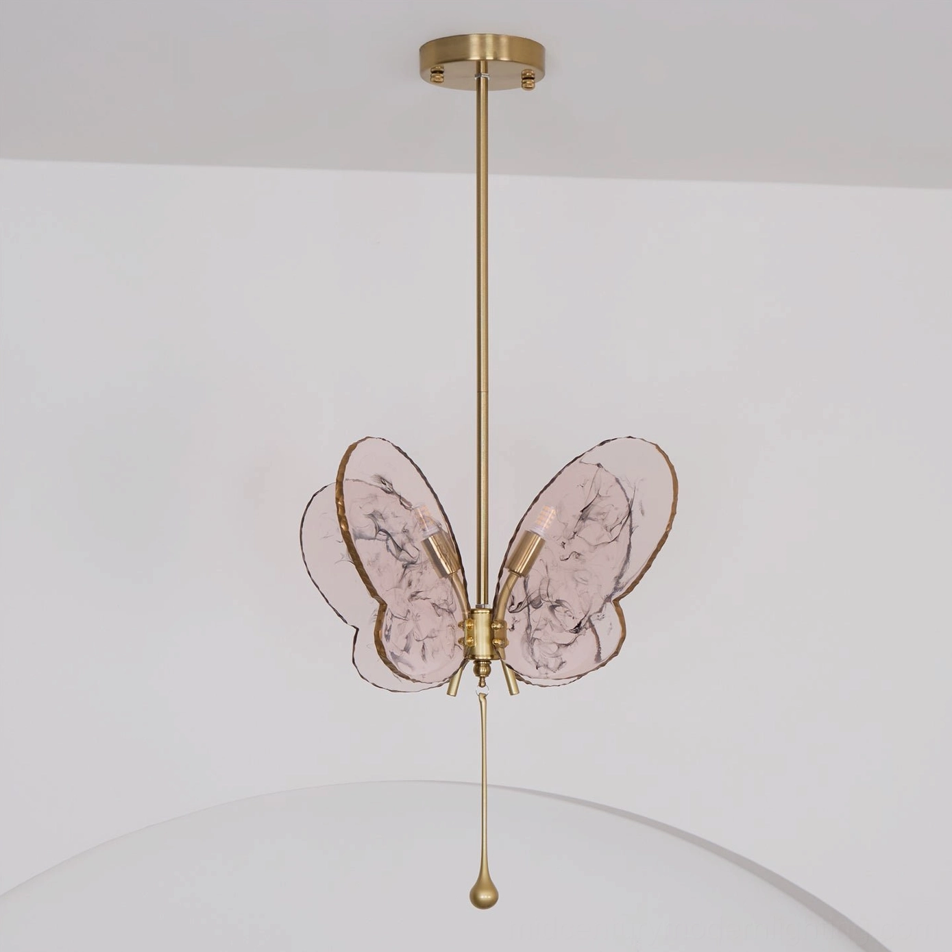Mid-century modern pink butterfly pendant lamp showing marbled translucent glass wings and brass metalwork