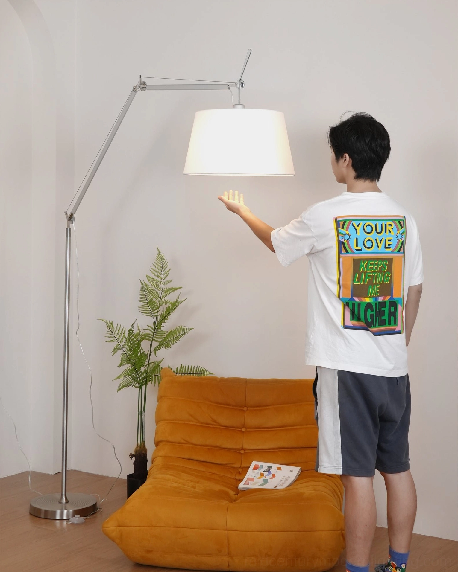 Mid-century modern floor lamp with adjustable swing arm design, fog silver finish complementing minimalist interiors