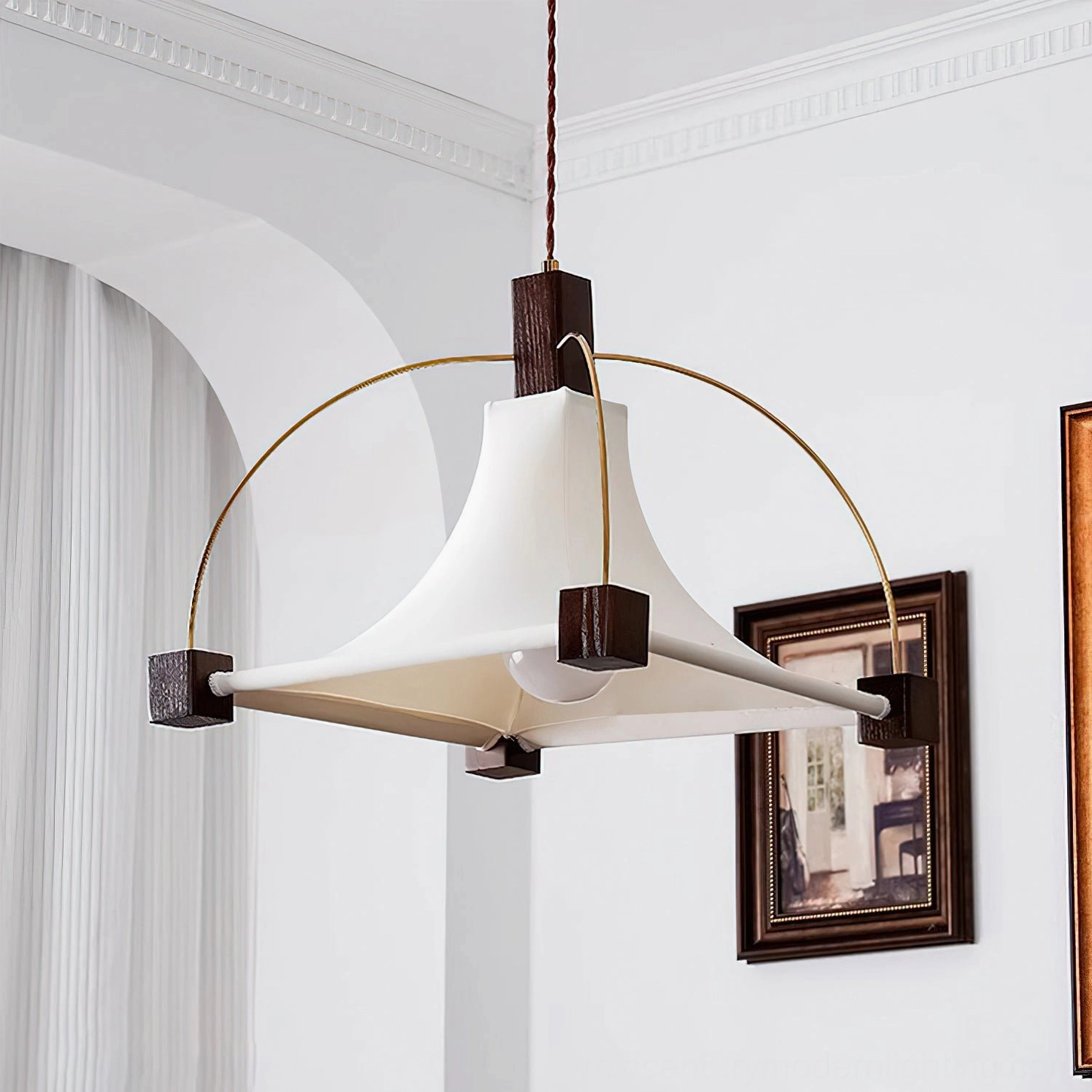 Hood pendant light displaying mid-century aesthetic with framed artwork