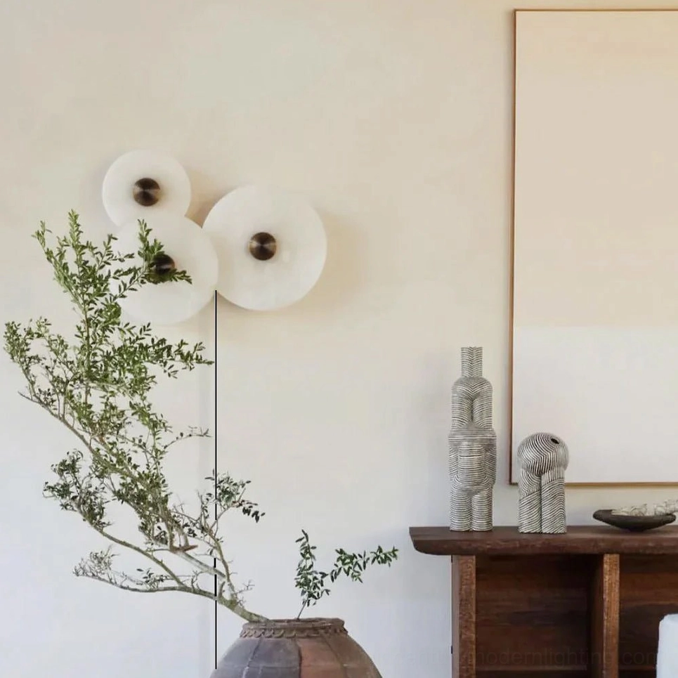 Sculptural alabaster wall lamp installation alongside dark wood vintage furniture in mid-century modern bedroom