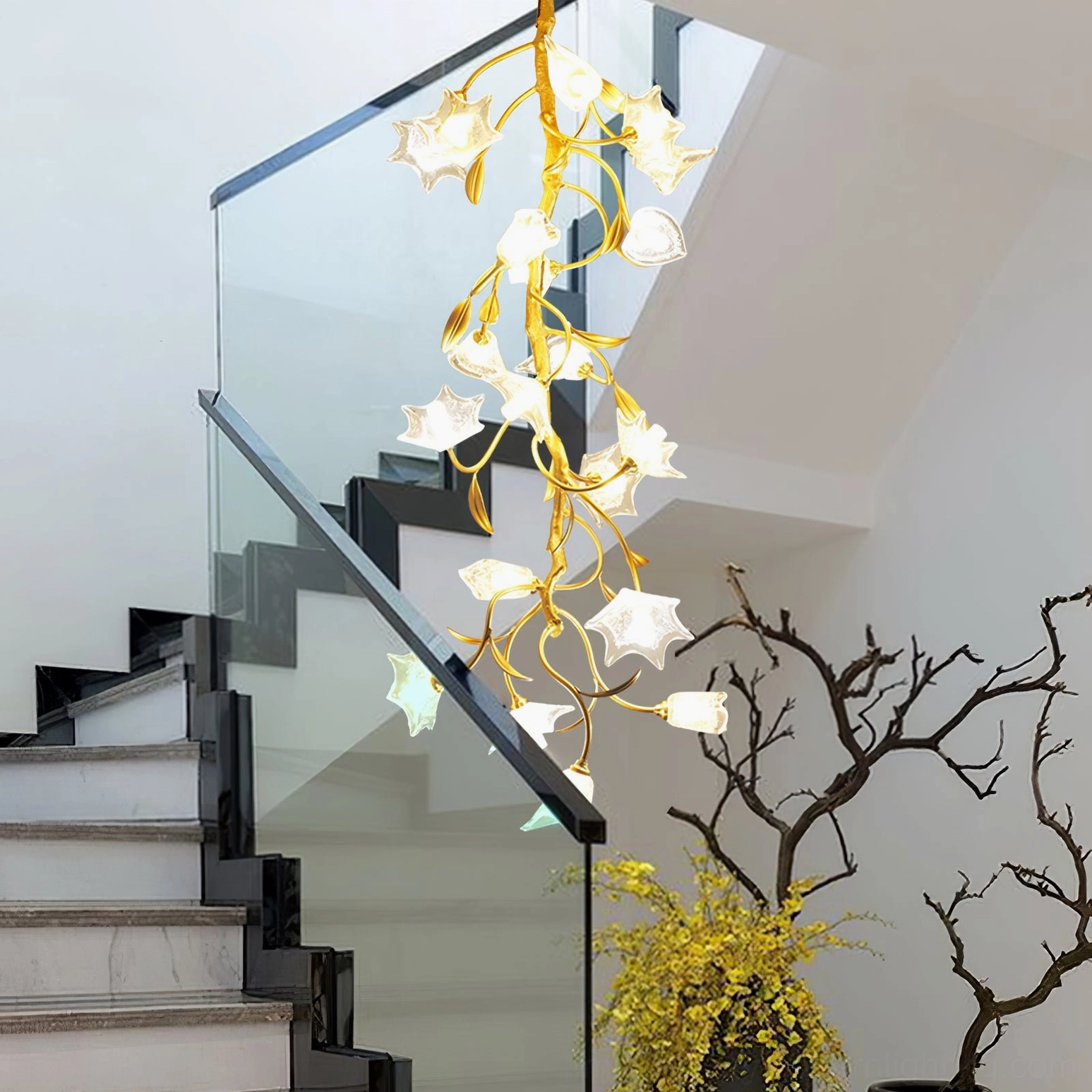 Mid-century modern botanical chandelier suspended above stairwell with glass railing and warm ambient lighting