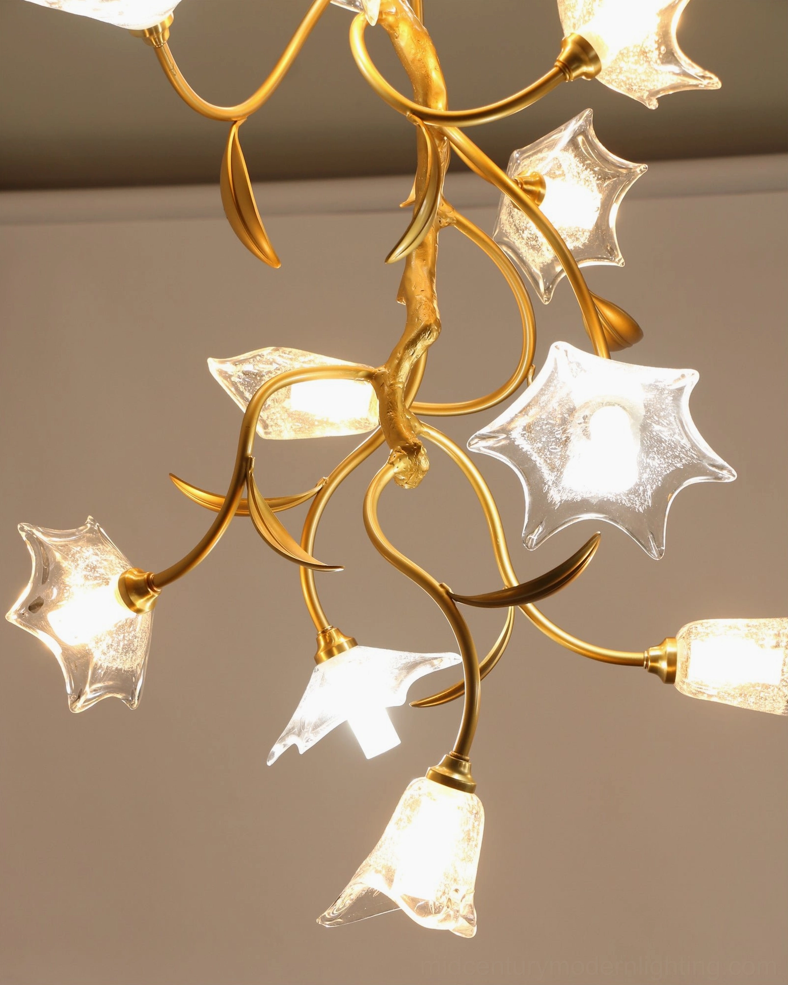 Mid-century modern floral chandelier installed in high-ceiling residential space with artistic lighting design