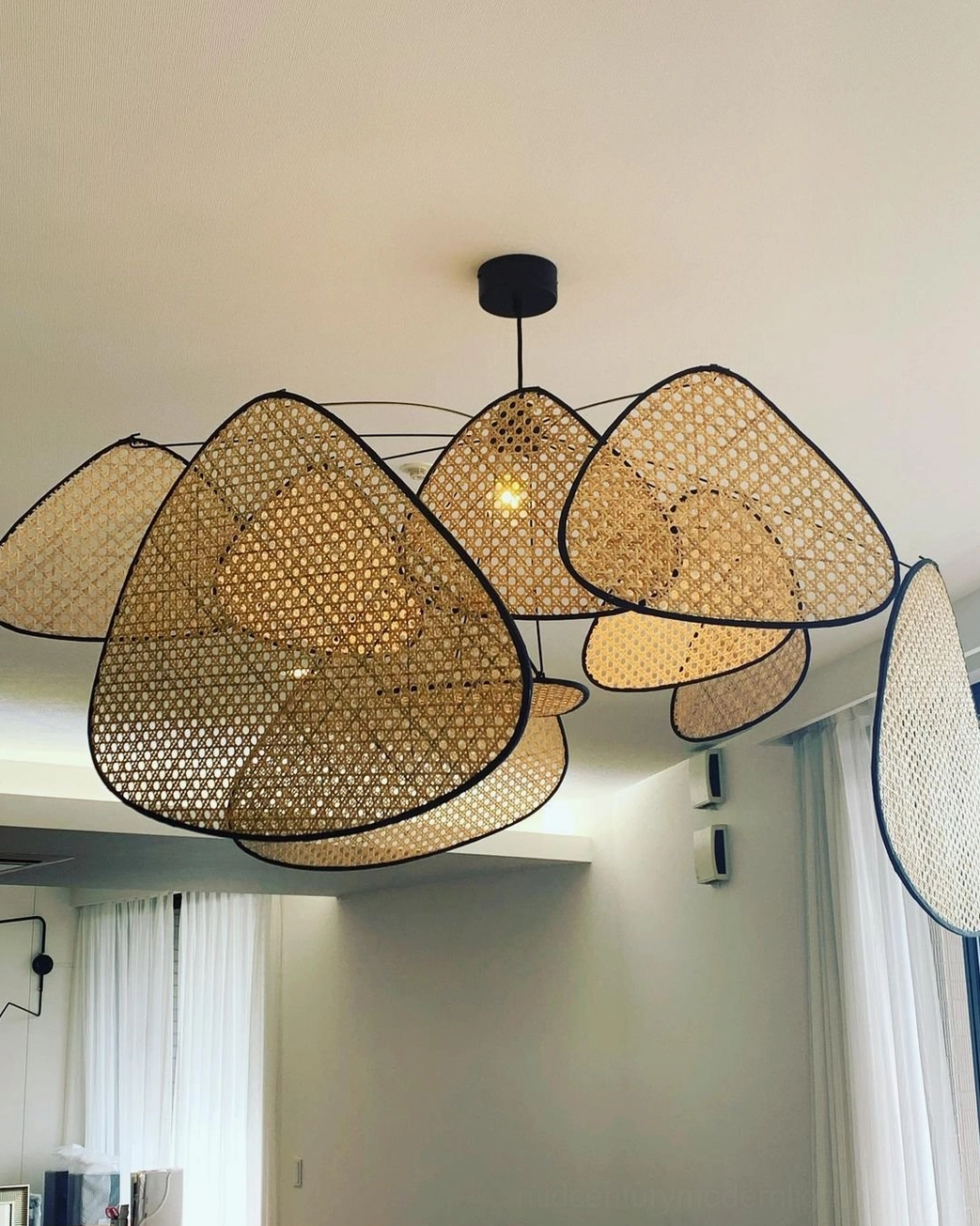 Mid-century modern rattan pendant light styled in contemporary home interior, natural material aesthetic