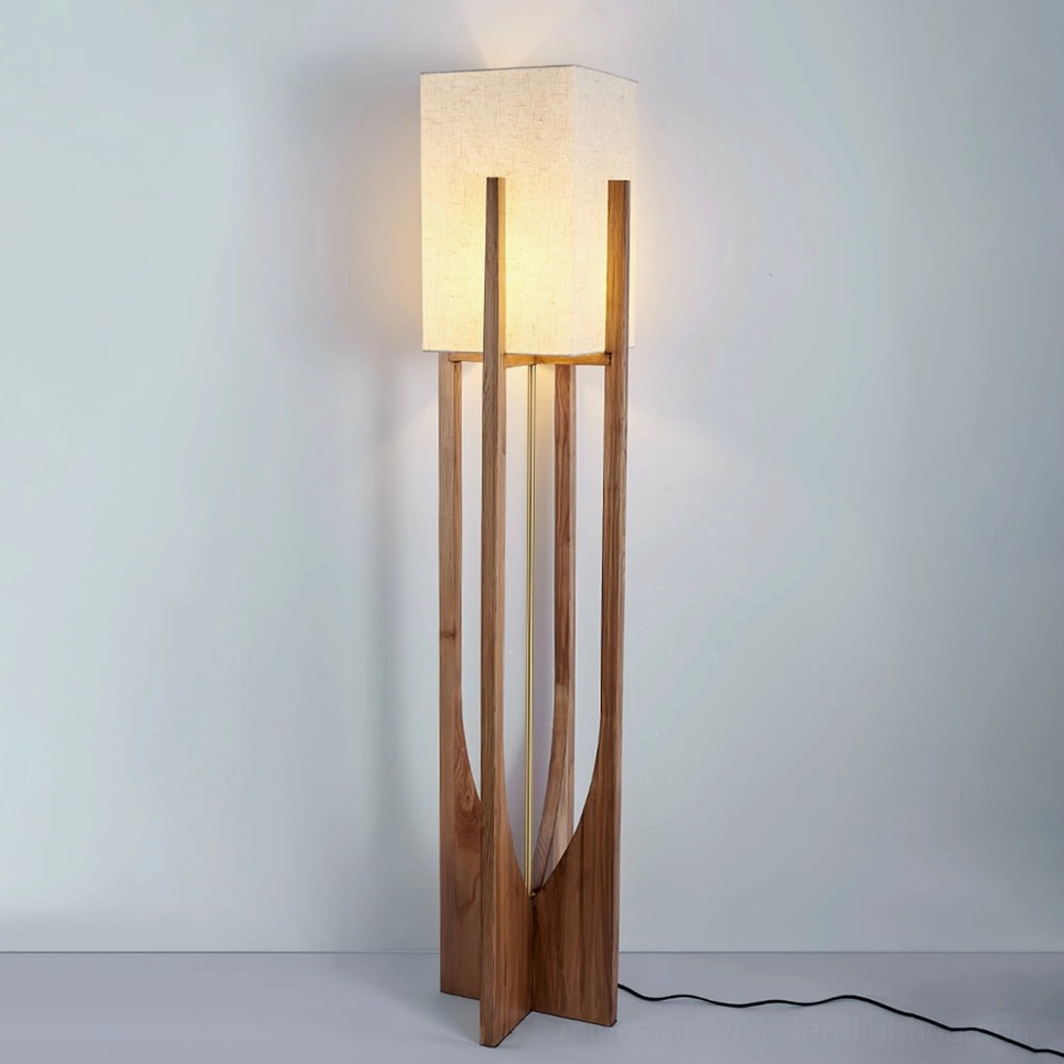 Slim natural wood floor lamp with white fabric shade three-quarter front view on off-white background
