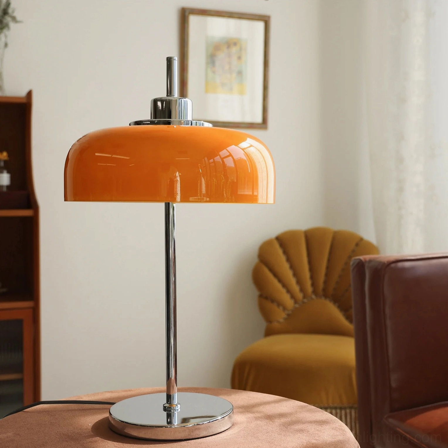 Mid-century modern orange lamp with shell-shaped velvet chair and framed art in minimalist vintage space