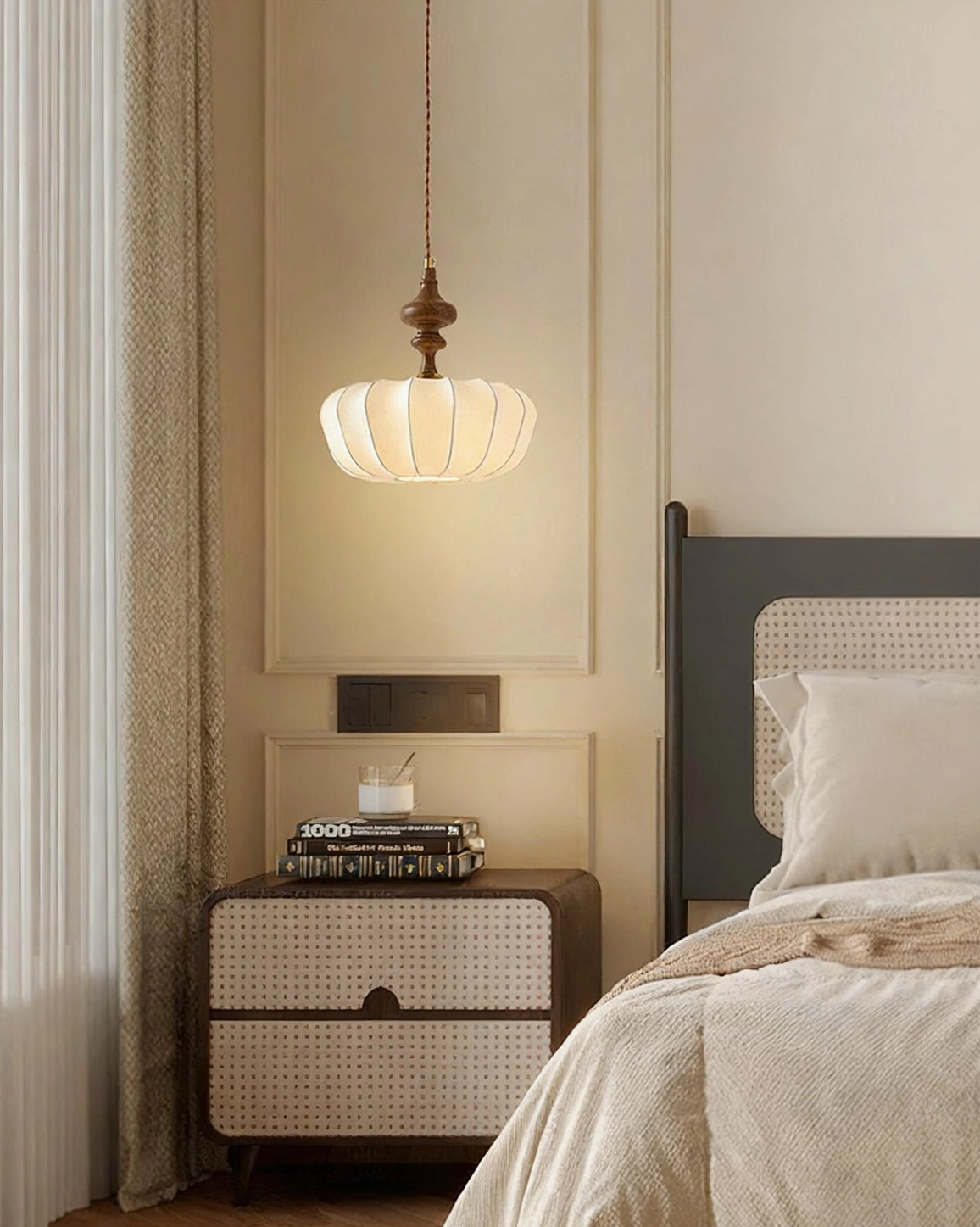 Mid-century pumpkin pendant light creating warm ambient glow in minimalist master bedroom