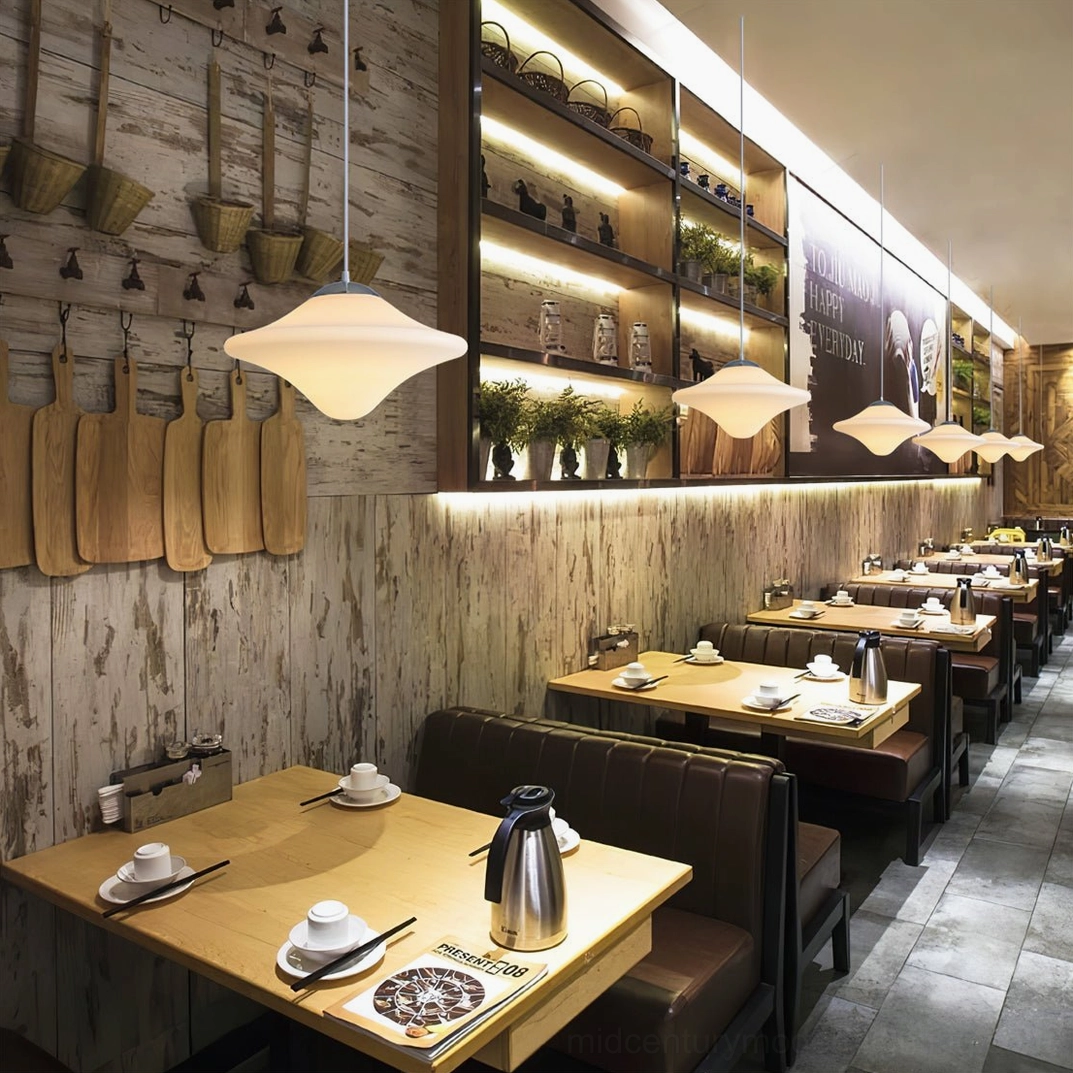 Mid-century pendant fixture over dining table creating warm inviting atmosphere and design focus