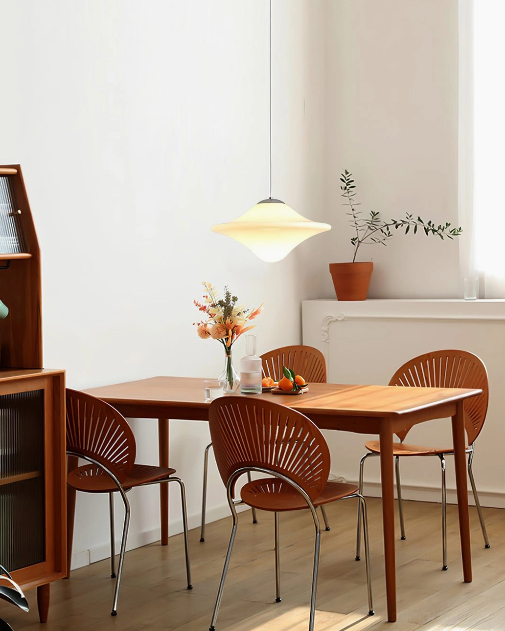 Single pendant lamp in minimalist dining room with warm neutral wabi-sabi style home decor