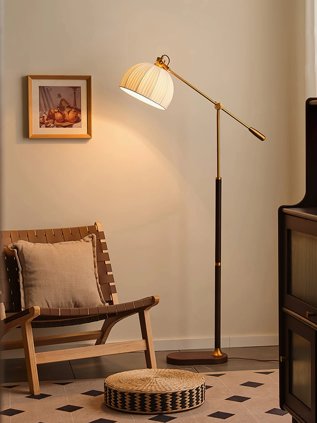 Mid-century reading floor lamp with walnut wood pole, brass hardware and round base positioned in cozy reading nook with wooden chair