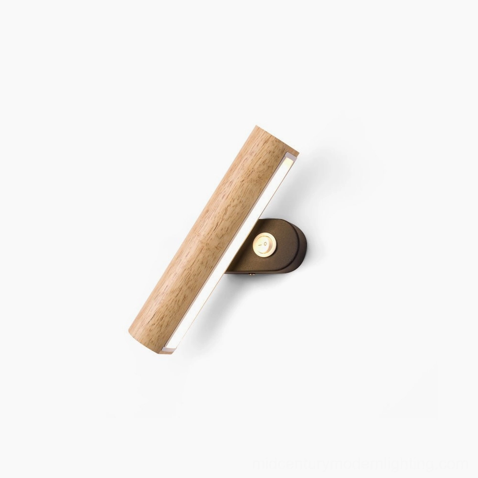 Mid-century modern rotatable tube wall lamp in natural wood finish, studio overhead view with minimalist white background